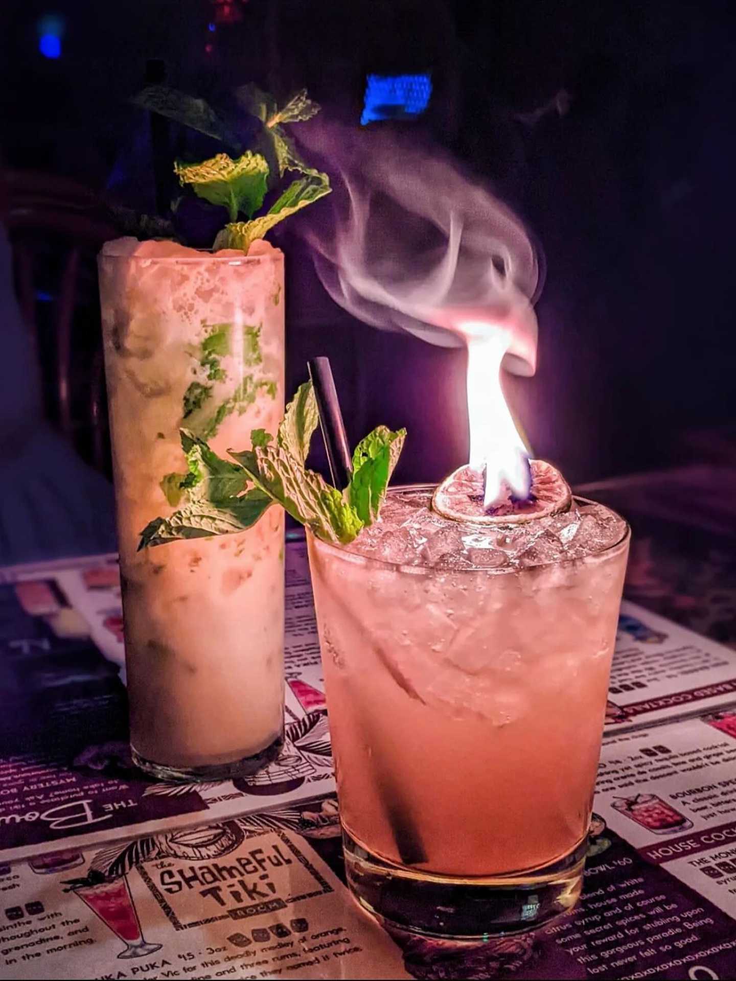 The best bars in Toronto | A flaming tiki cocktail and a creamy cocktail at The Shameful Tiki Room