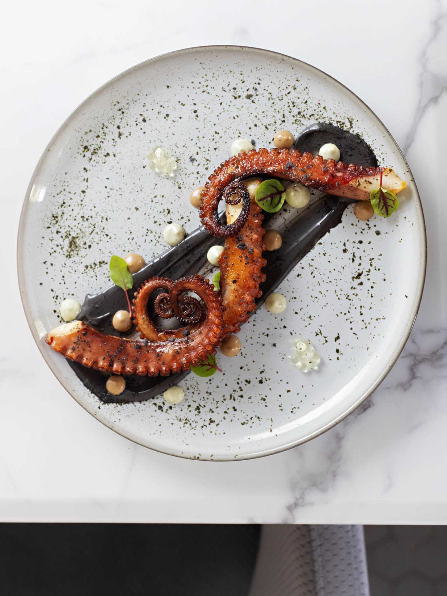 Charred octopus at ēst on Queen East