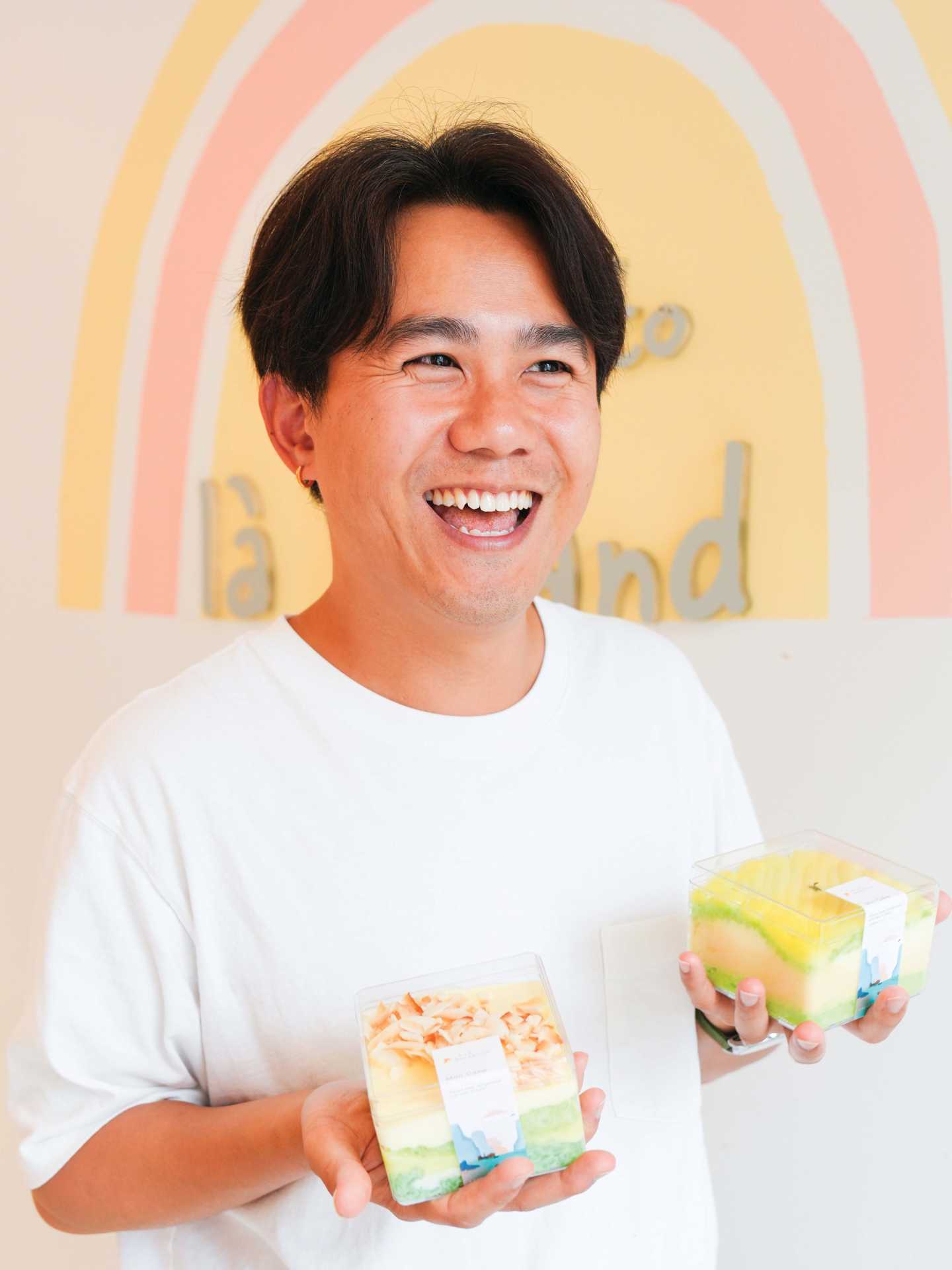 Brian Tran holding treats from Là Lá Bakeshop