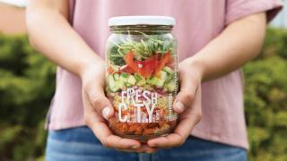 Someone holding a salad jar from Fresh City Farms