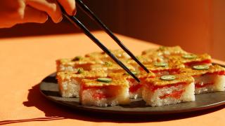 Best sushi in Toronto | Chopsticks reach for a platter of salmon oshi at Minami Toronto