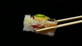 Best sushi in Toronto | Chopsticks hold a piece of yellowtail oshi at Minami Toronto