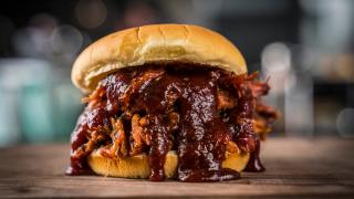 A juicy pulled pork sandwich cooked on a Traeger grill