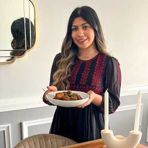 Ontario veal | Fariha Ekra holding her veal curry and smiling at the camera