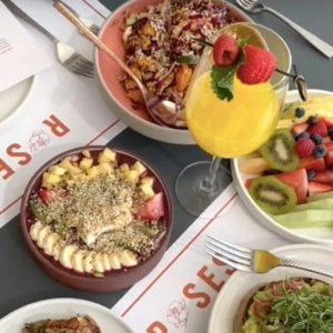 Bowls of fruit and mimosas on a table at Roses Cocina