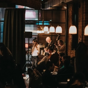 Musicians on stage playing music at a bar