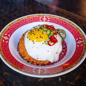 A dish topped with an egg at OddSeoul