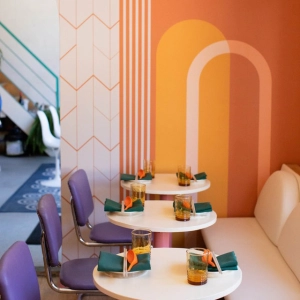 Purple chairs and a pastel wall at Simpl Things in Parkdale