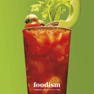 A large caesar cocktail over a green background