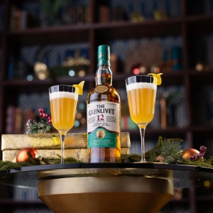 A bottle of The Glenlivet on a table with rocks glasses