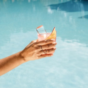 A summer cocktail by a pool with Ramsbury gin