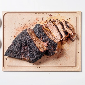 An Epicurean cutting board with a sliced roast