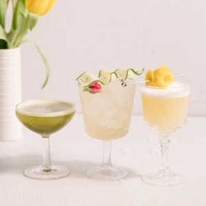 Three summery cocktails with intricate garnishes