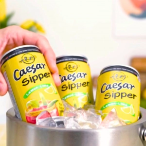 Three cans of Matt & Steve's Caesar Sippers in a bucket of ice