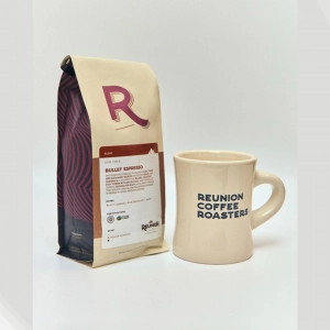 A bag of Reunion's Bullet Espresso with a Reunion mug