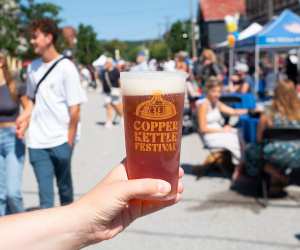 Holding a pint of beer at Copper Kettle Festival in Creemore, Ontario