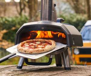 Taking a pizza out of the Ooni Karu 12G pizza oven
