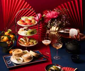 A cake stand of treats, bamboo steamer baskets, tea and sparkling wine at Holts Café Lunar New Year Afternoon Tea