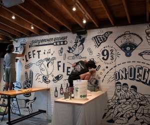 Toronto artist Cam Miller creating a mural at Left Field Brewery