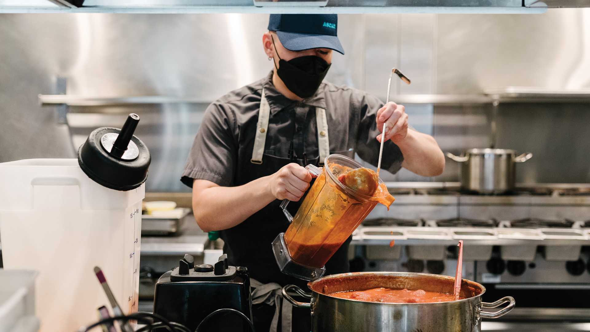 Toronto restaurant industry recovery | A cook dons a mask while he works at Ascari on King