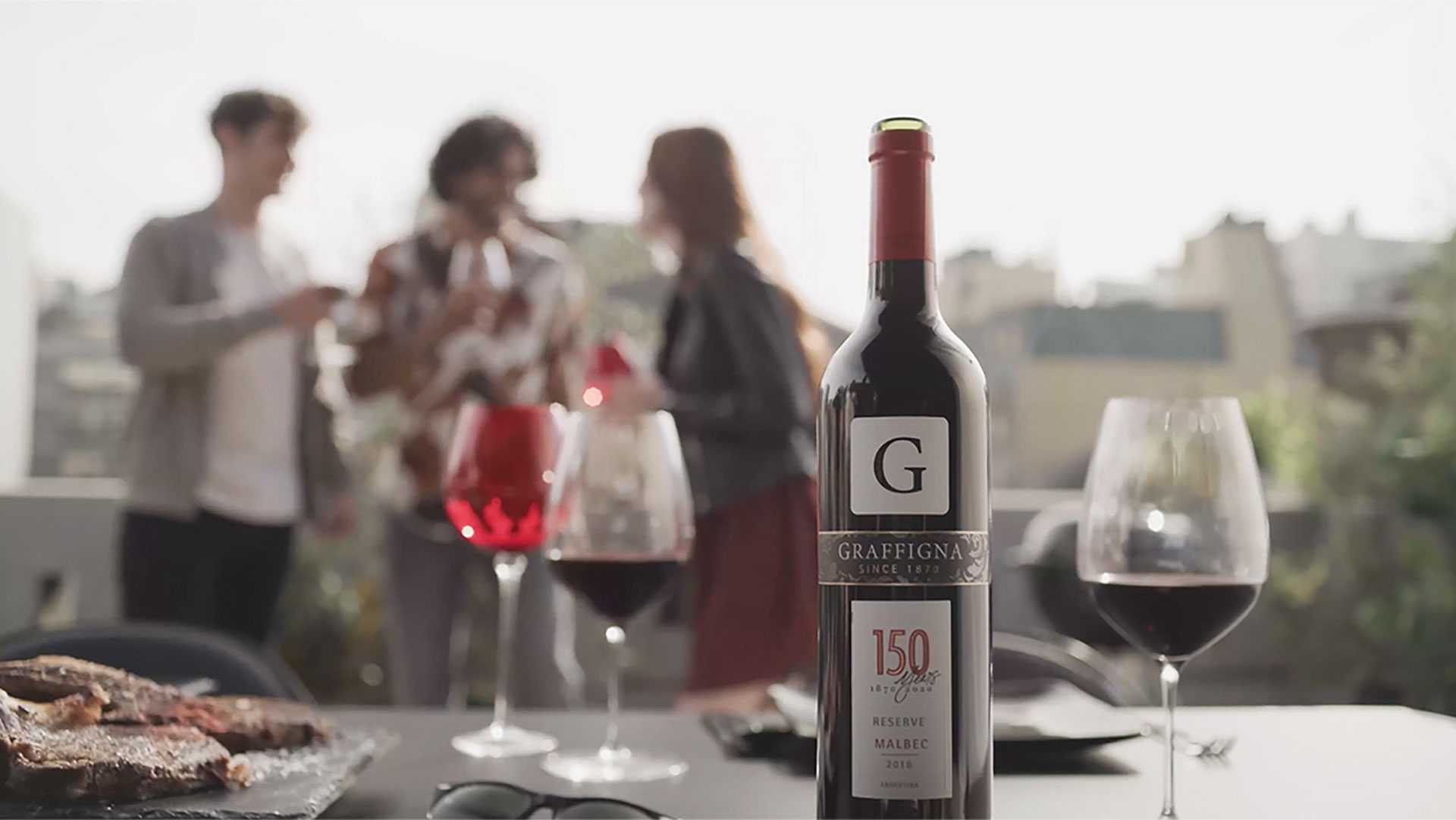 Graffigna | A bottle of Graffigna and wine glasses at a party Graffigna | A bottle of Graffigna and wine glasses at a party