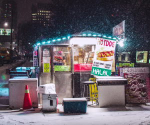 Things to do in Toronto this January 2021 | Snow falls on a hot dog stand beside Nathan Phillips Square