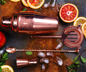 Cocktail recipes and tips from Toronto's best bartenders | A rose gold shaker, strainer and stir spoon surrounded by fruit