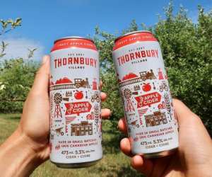 Two people cheers with Thornbury Premium Apple Cider