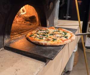 Pizza going into the oven at Cellar Door Restaurant