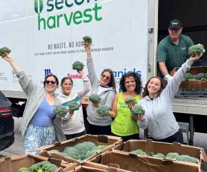 A group of Second Harvest volunteers holding up rescued broccoli