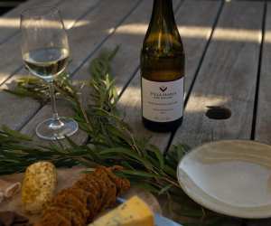 Villa Maria Private Bin Sauvignon Blanc on a picnic table with a glass and charcuterie