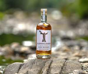 A bottle of Glendalough Double Barrel Irish Whiskey in a nature setting