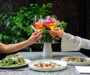 People cheers wine glasses on the patio at Sofia Restaurant in Yorkville, Toronto